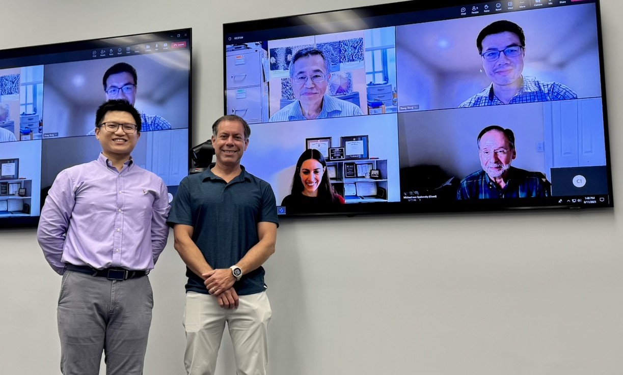Photograph of Che-Wei Chang standing with Dr. Burgos after his defense.