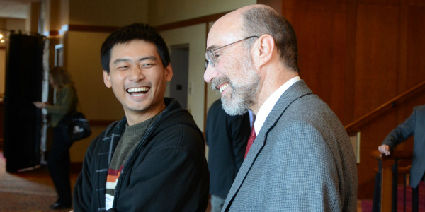 Two CPES researchers share a joke 